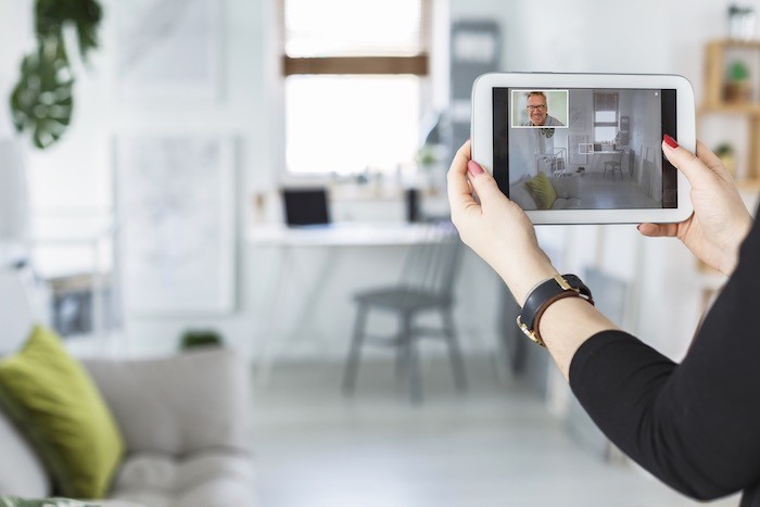 Woman holding tablet video call.